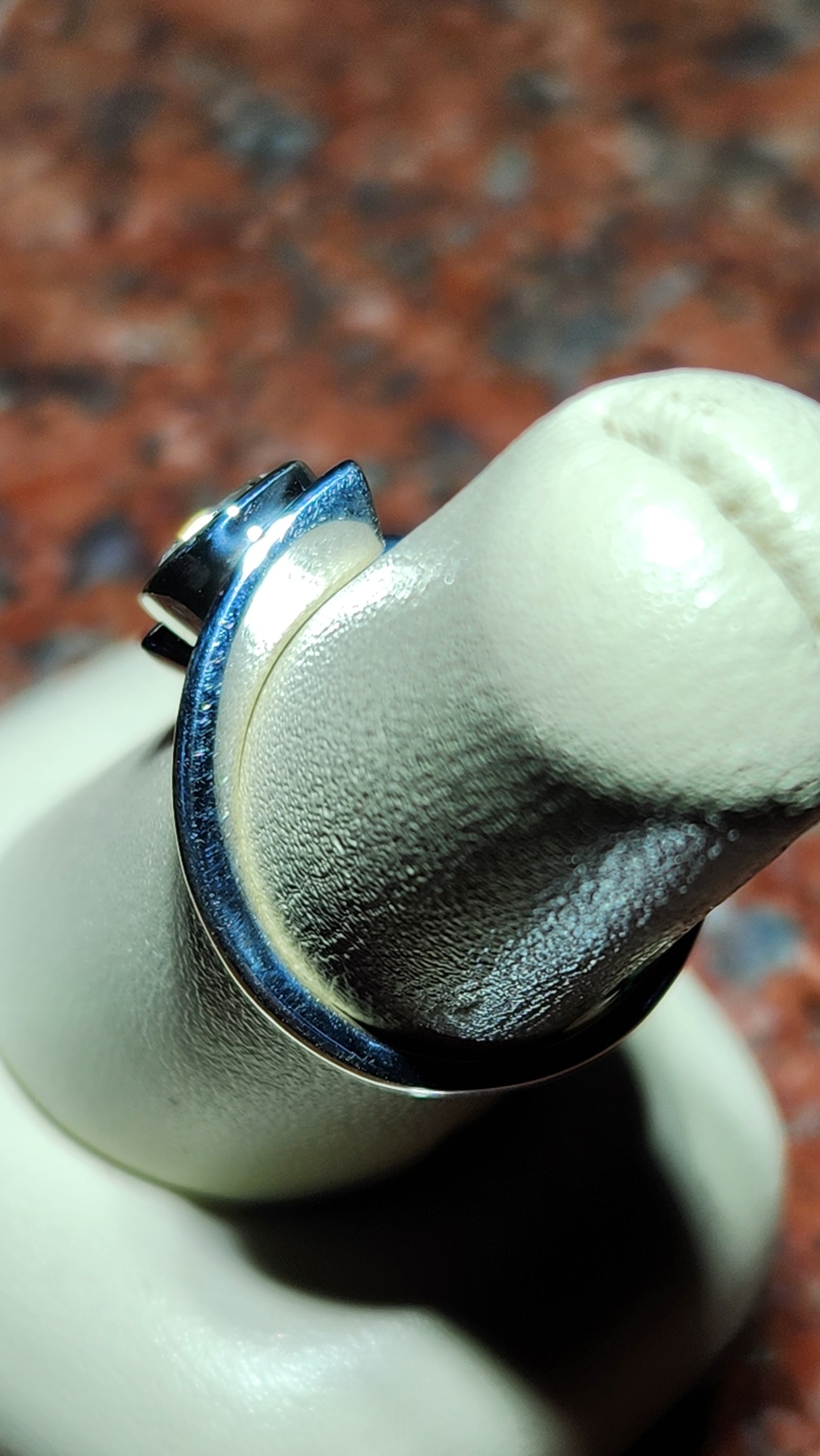0.95ct Mason County clear star brilliant cut topaz bezel set in a bypass style ring in contiuum silver.