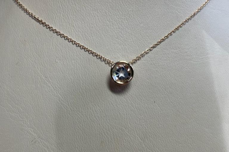 0.95ct Texas topaz is mounted into a 14kt yellow gold slide and chain.