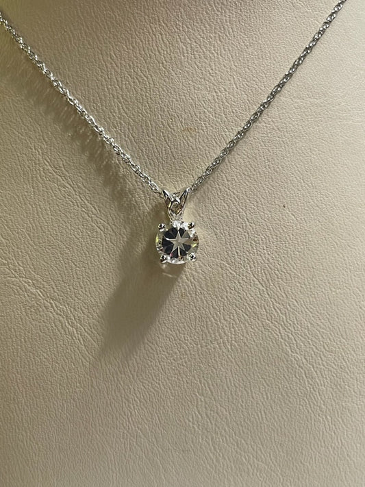 0.5ct natural clear star brilliant cut Texas topaz is set in a sterling scroll silver pendant.