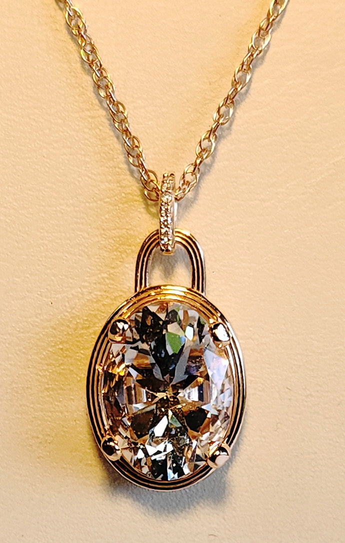 6.89ct Pink Texas topaz set in a 14kt pink gold setting with diamond accents on an available 18" - 14kt chain.