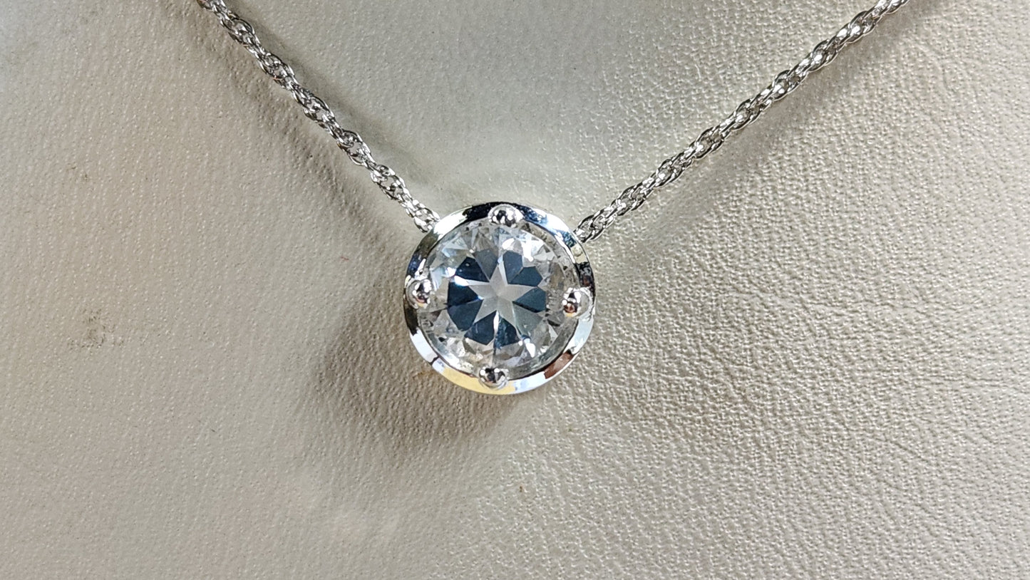 1.45ct clear star brilliant cut Texas topaz is set in a sterling silver slide pendant and chain.