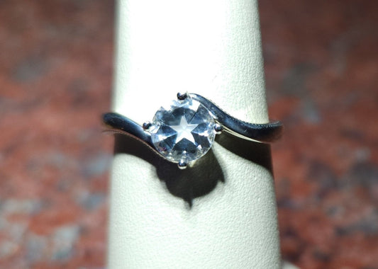 0.95ct Mason County clear star brilliant cut topaz mounted in a bypass style ring in contiuum silver.