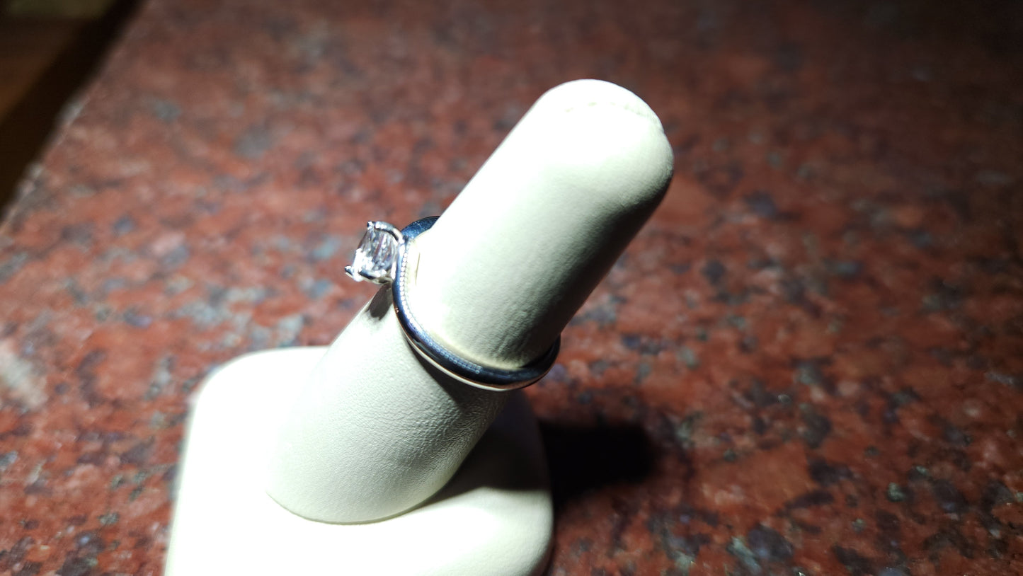 0.95ct Mason County clear star brilliant cut topaz mounted in a bypass style ring in contiuum silver.