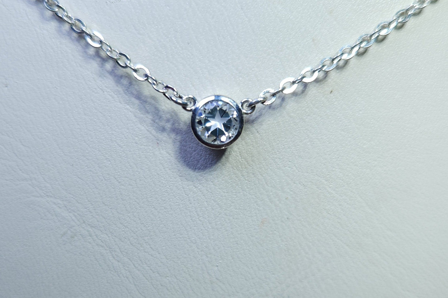 0.45ct clear star brilliant cut Texas topaz is set in a small sterling silver pendant and chain