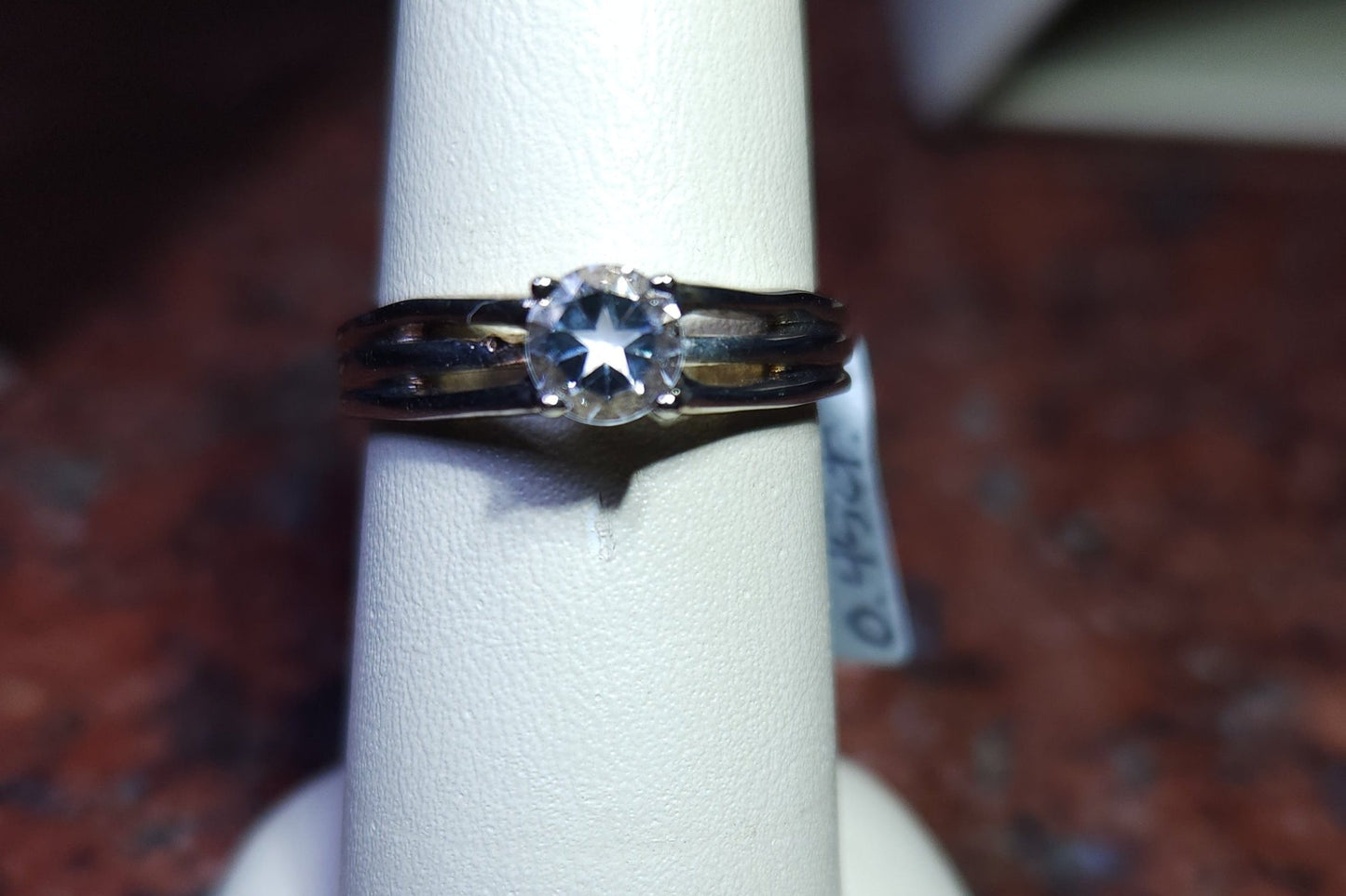 0.45ct Mason County clear star brilliant cut topaz mounted in a sterling silver ring with a 14kt white gold head.