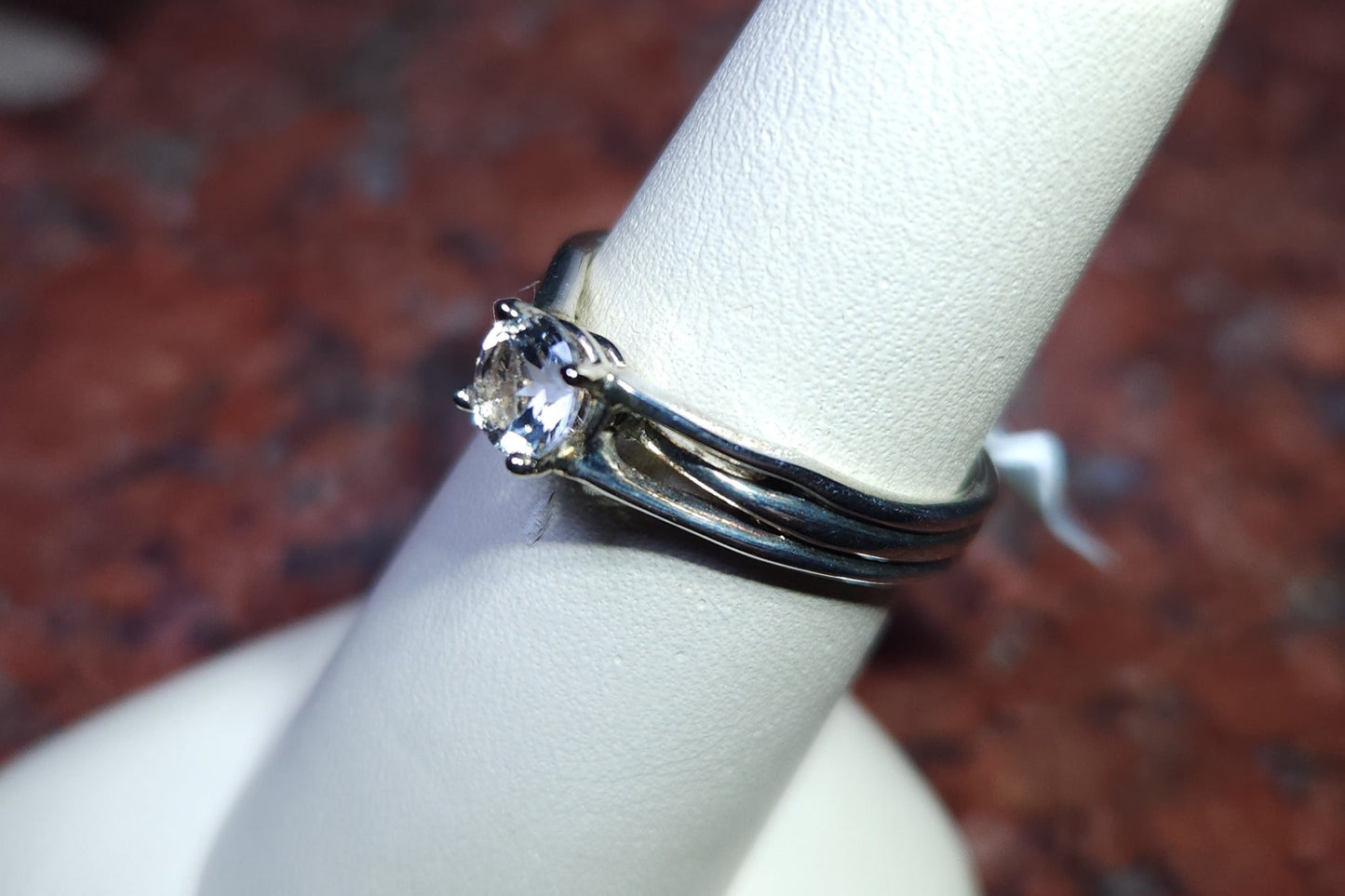 0.45ct Mason County clear star brilliant cut topaz mounted in a sterling silver ring with a 14kt white gold head.