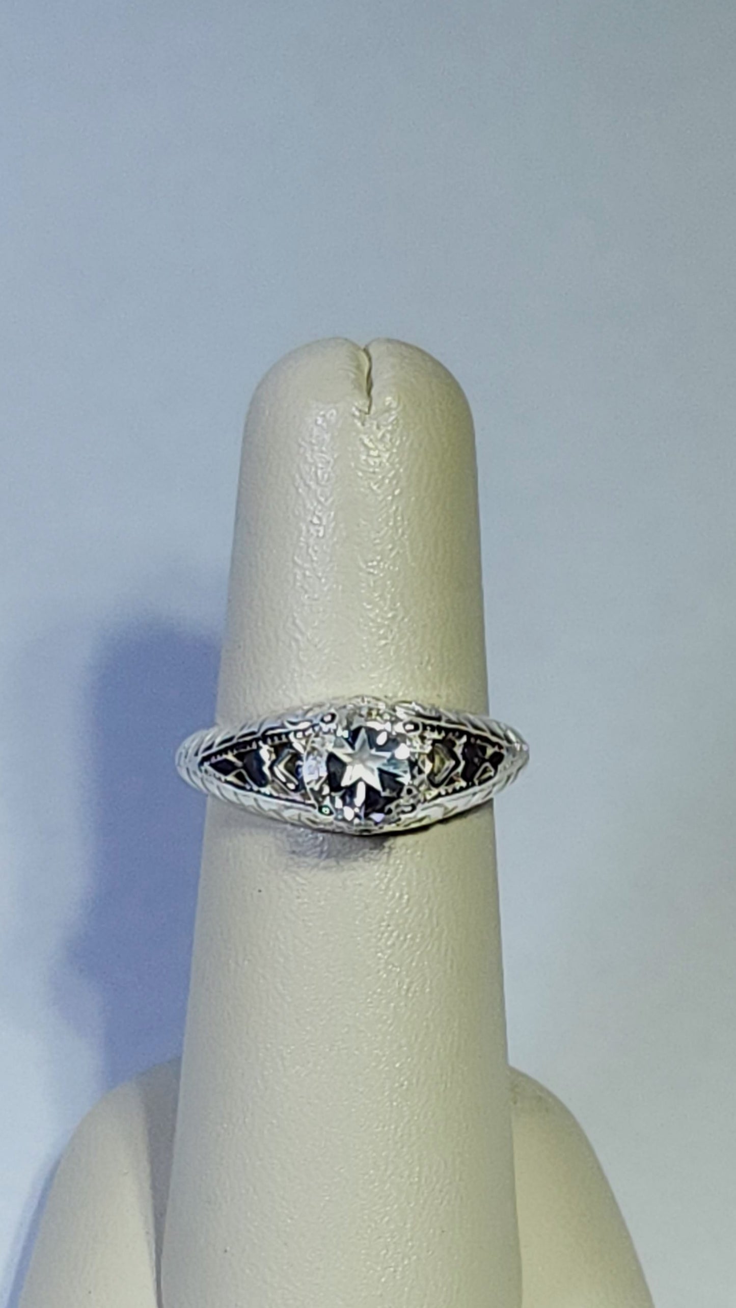 0.95ct clear star brilliant cut Texas topaz is set in a sterling silver filigree ring with hearts.