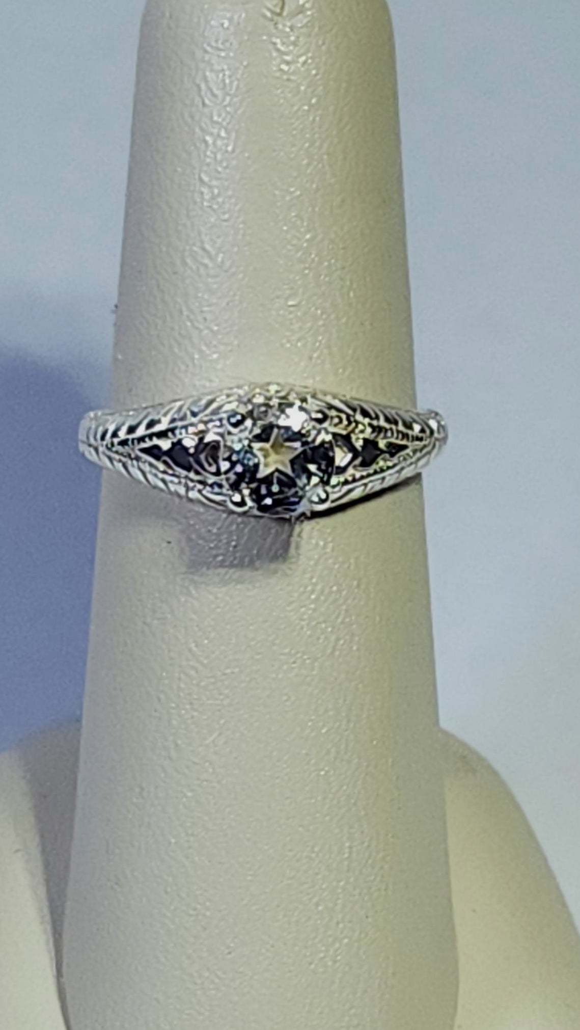 1.45ct clear star brilliant cut Texas topaz is set in a sterling silver filigree ring with hearts.