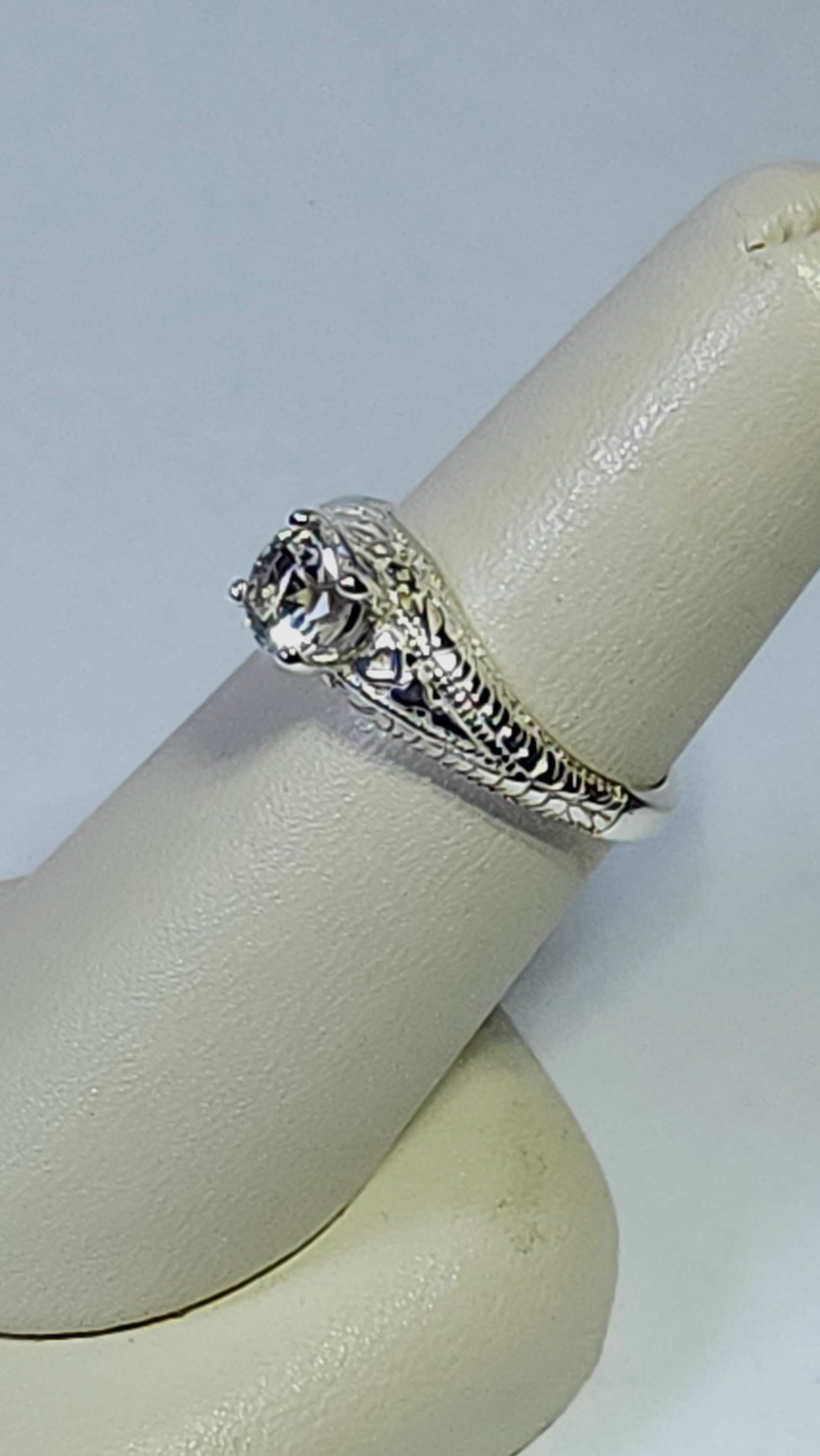 1.45ct clear star brilliant cut Texas topaz is set in a sterling silver filigree ring with hearts.