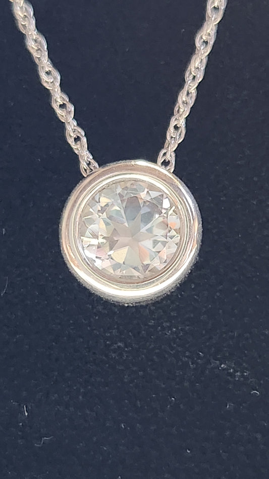 1.45ct clear star brilliant cut Texas topaz is back-set in a sterling silver slide pendant and chain.