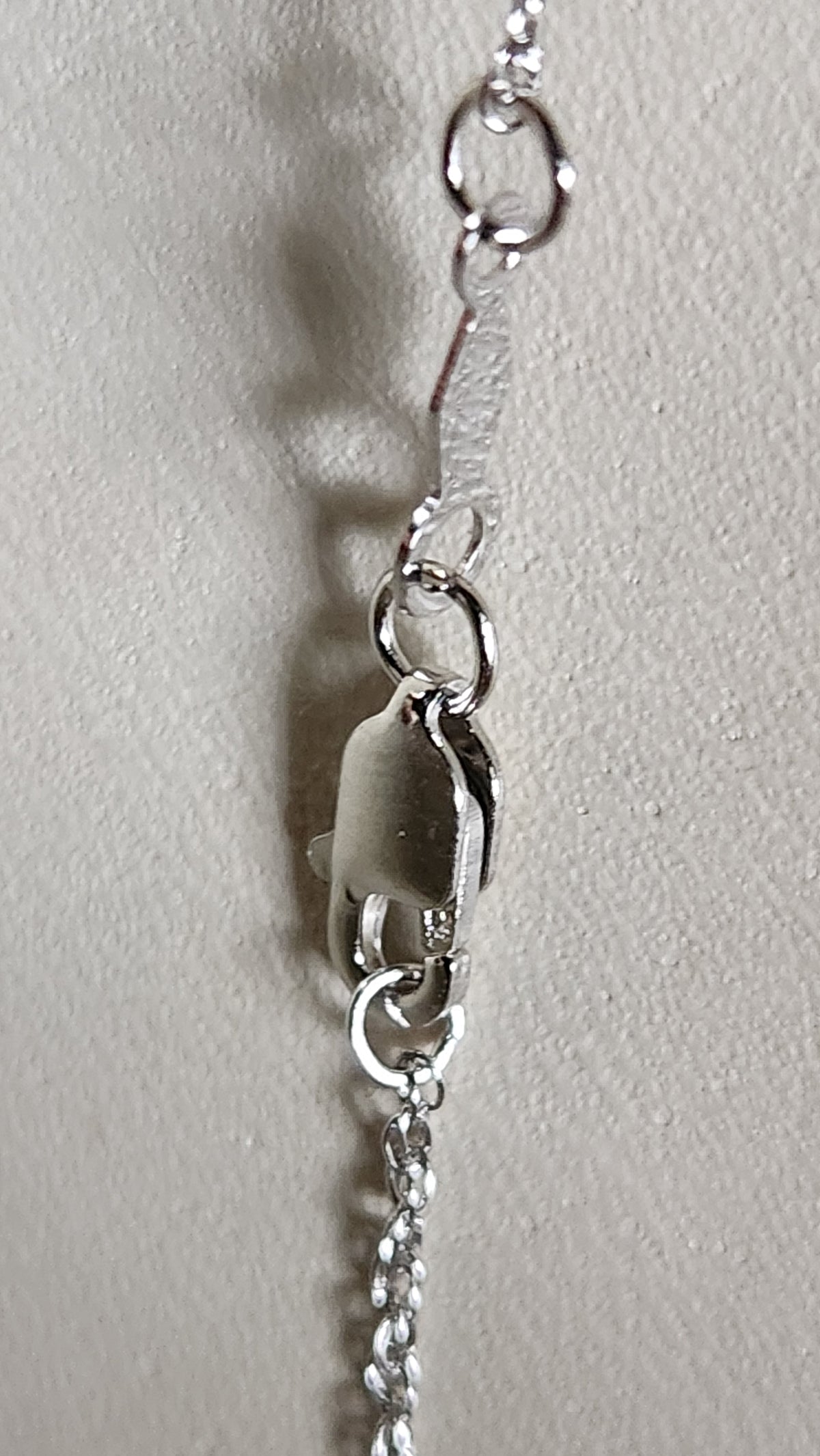 3.20ct natural blue star brilliant cut Texas topaz is set in a sterling silver scroll pendant and chain.