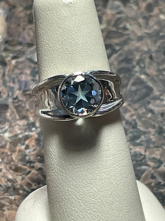 2.44ct Mason County natural Blue star brilliant cut topaz mounted in a white gold bezel on a Continuum silver ring