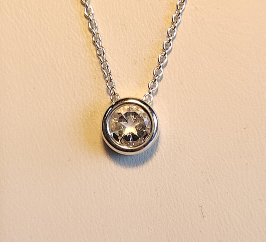 1.45ct clear star brilliant cut Texas topaz is set in a small sterling silver bezel pendant.