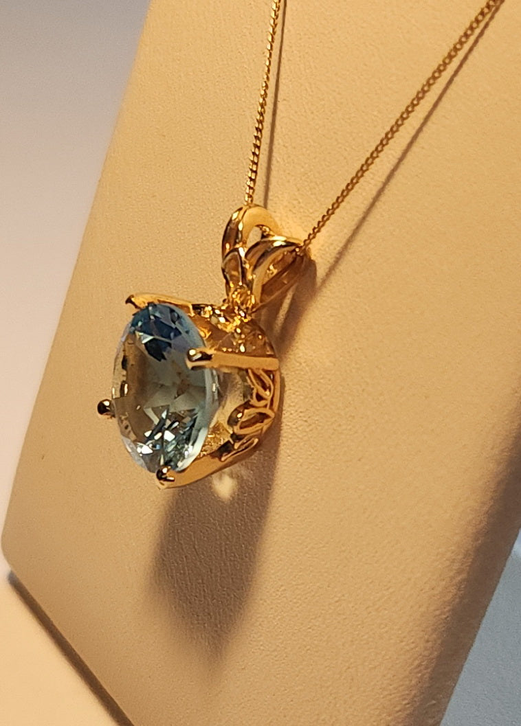 3.89 ct Swiss blue brilliant cut topaz is set in a 14kt yellow gold pendant with/out a 16" gold chain.