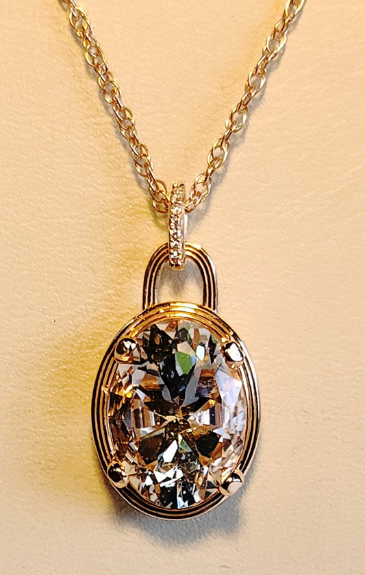 6.89ct Pink Texas topaz set in a 14kt pink gold setting with diamond accents on an available  18" -  14kt chain.