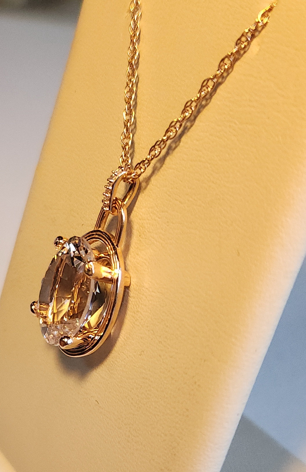 6.89ct Pink Texas topaz set in a 14kt pink gold setting with diamond accents on an available  18" -  14kt chain.