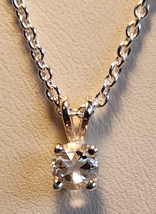 0.45ct clear star brilliant cut Texas topaz is set in a small sterling silver pendant and chain